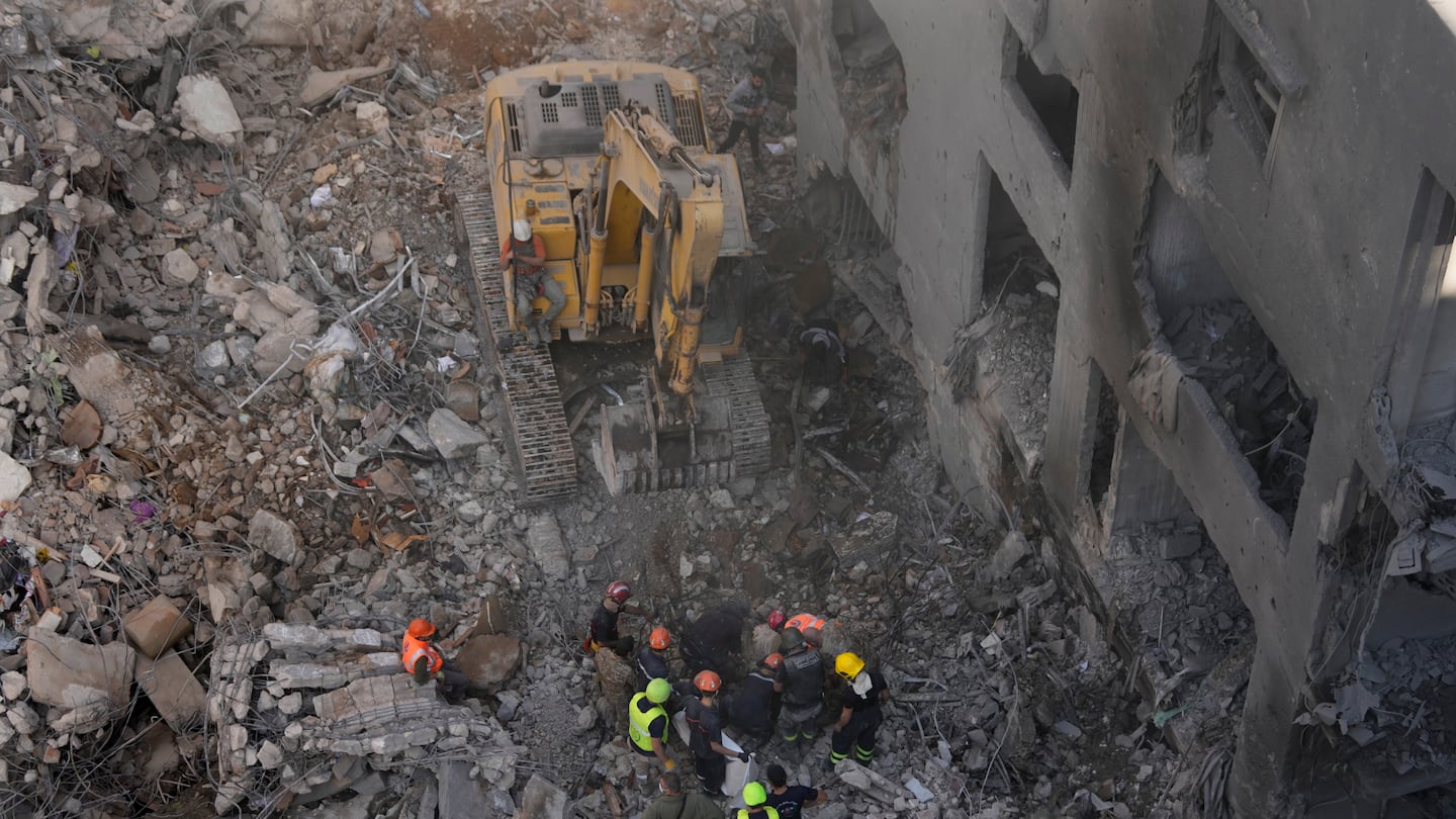 Rescue workers search for victims at the site of an Israeli airstrike that hit central Beirut, Lebanon, on Nov. 23.