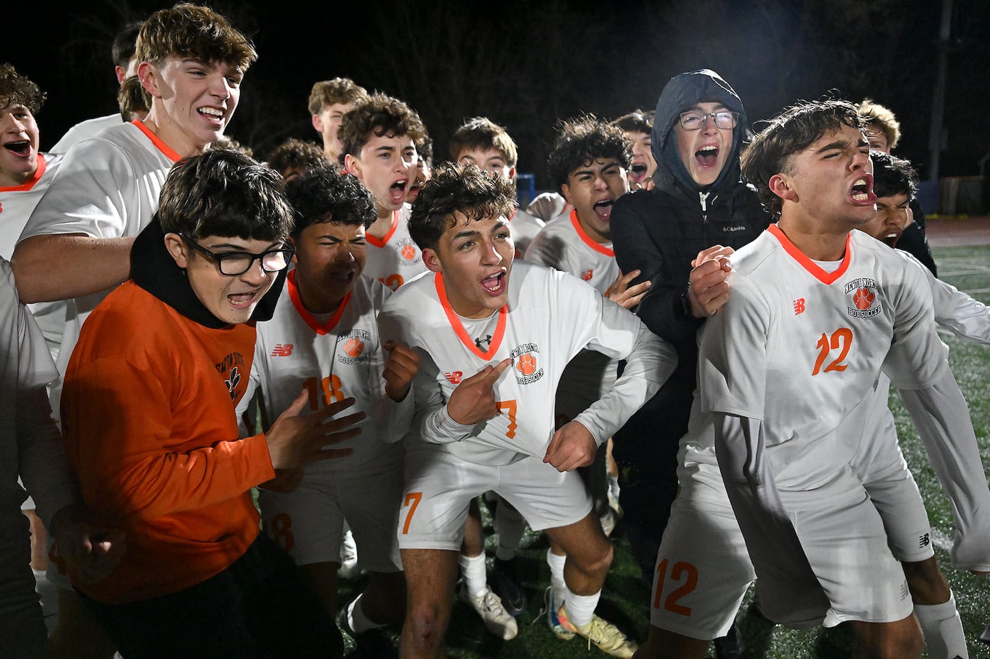 Euphoric Newton North players celebrate their unprecedented title.