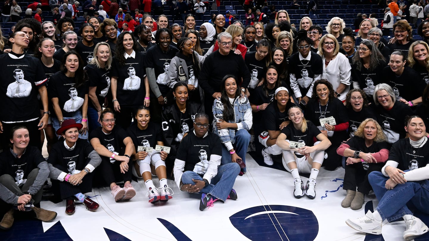 UConn women's coach Geno Auriemma was joined by 60 former and current players after setting the record for most wins in college basketball history.