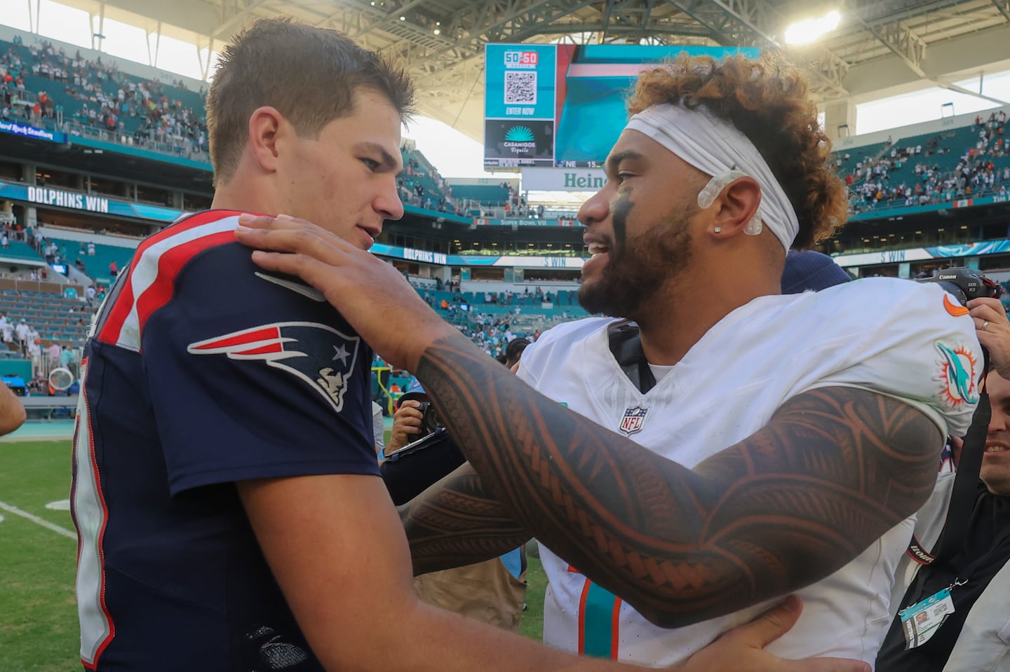 “You’re getting first and 20s and second and 16s, it’s just hard,” said quarterback Drake Maye (left), who shared a postgame moment with Miami's Tua Tagovailoa. “It’s hard to pick up first downs and move the ball.”