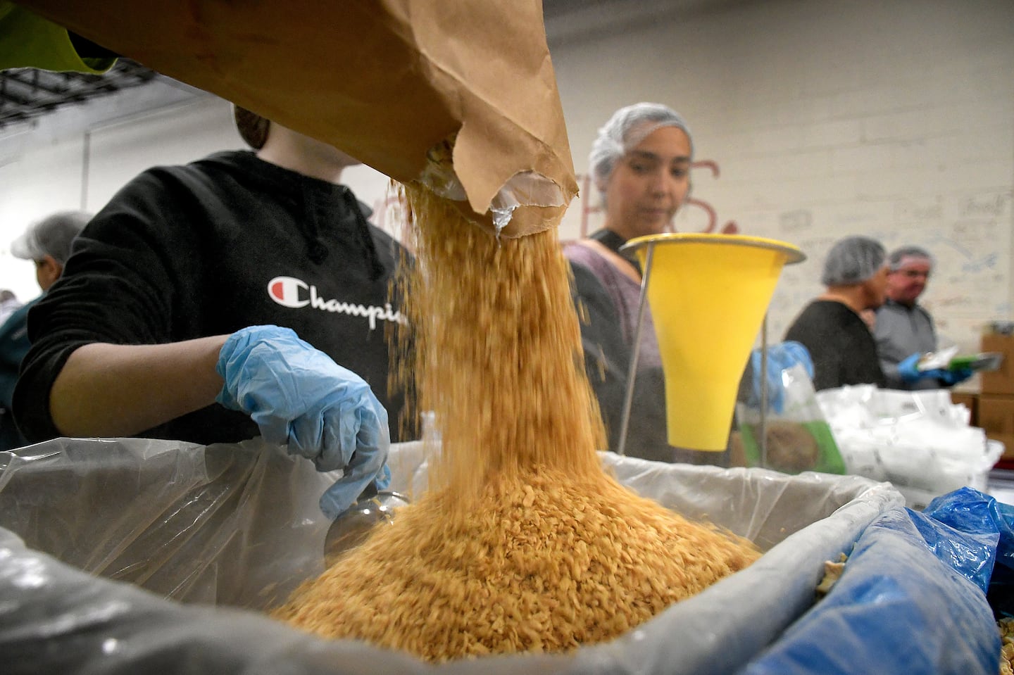 Volunteers came together on Sunday morning at the End Hunger Warehouse and Packaging Center to package over three hundred thousand meals for those in need in New England.