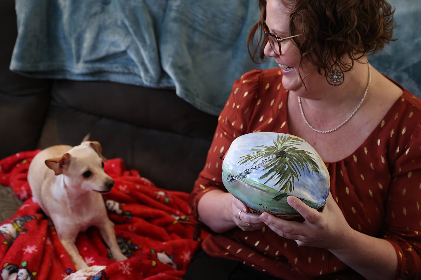 Colleen Glenney, a Roslindale resident, holding a painted coconut, a memento from her stint living in Florida.