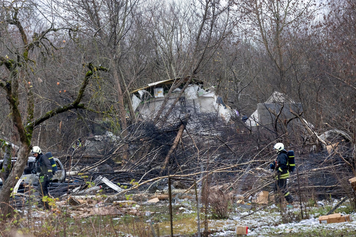 Lithuanian Emergency Ministry employees work near the site where a DHL cargo plane crashed into a house near the Lithuanian capital Vilnius, Lithuania, on Nov. 25.