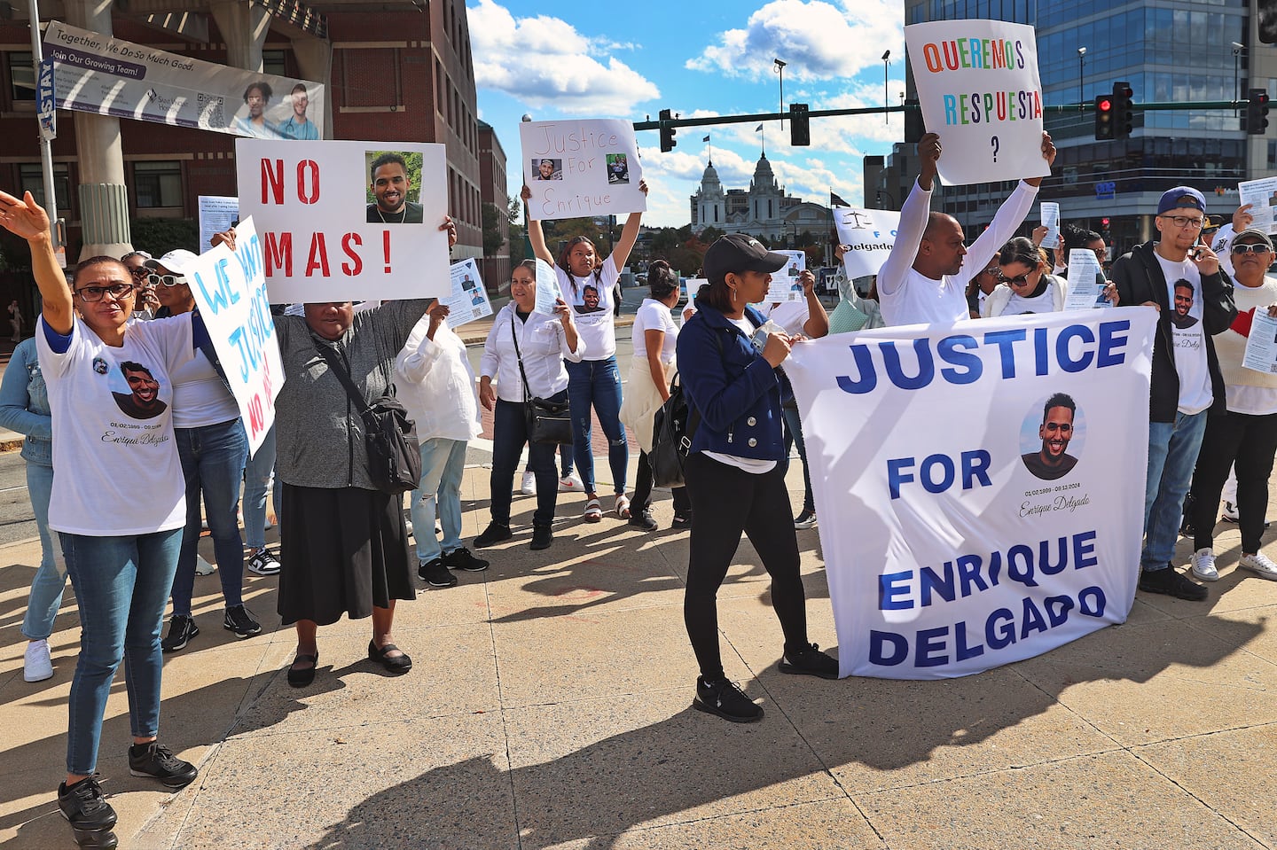 Demonstrators outside at the DCU Center in Worcester where the State Police Academy graduation took place a month after recruit  Trooper Enrique Delgado-Garcia died as a cadet.