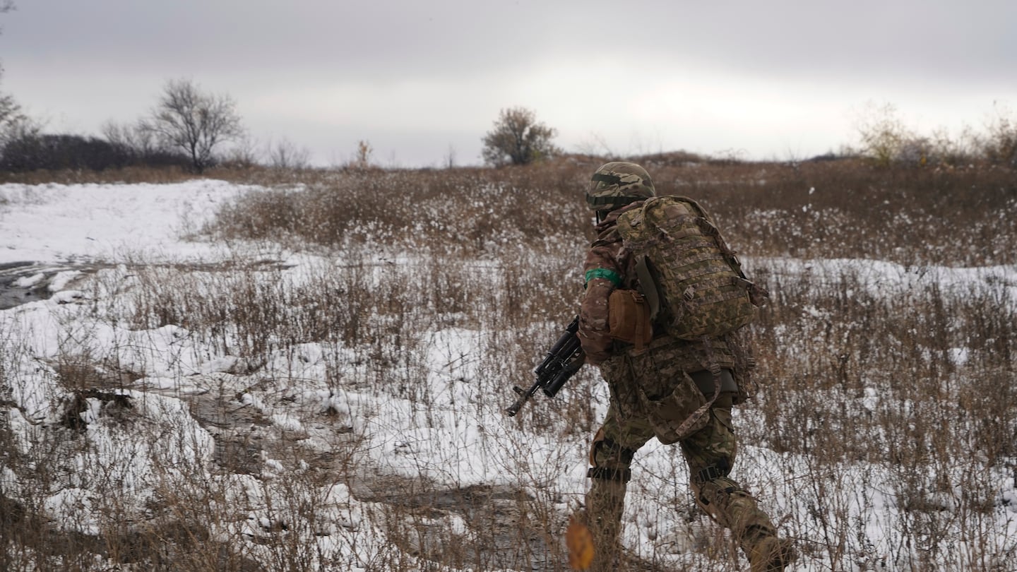 Ukrainian servicemen of 57th motorised brigade improve their tactical skills on obstacle course at the training field in Kharkiv region, Ukraine on Nov. 14.