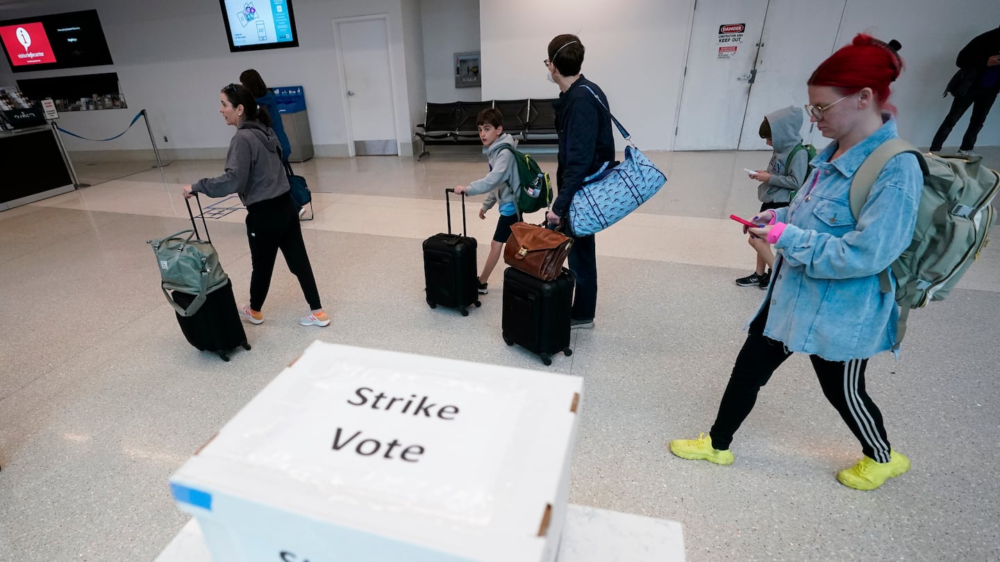 Passengers walks past a union ballot drop box at Charlotte Douglas International Airport on Nov. 22 in Charlotte, N.C.