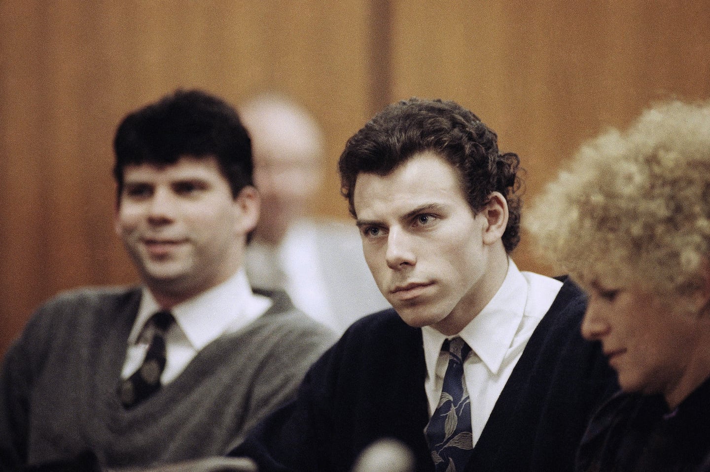 Lyle, left, and Erik Menendez sit with defense attorney Leslie Abramson, right, in the Municipal Court in the Beverly Hills area of Los Angeles, during a hearing, Nov. 26, 1990.