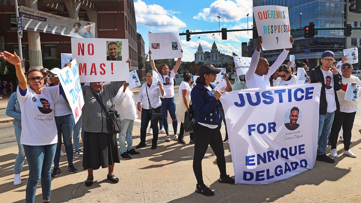 Demonstrators outside at the DCU Center in Worcester where the State Police Academy graduation took place a month after recruit  Trooper Enrique Delgado-Garcia died as a cadet.