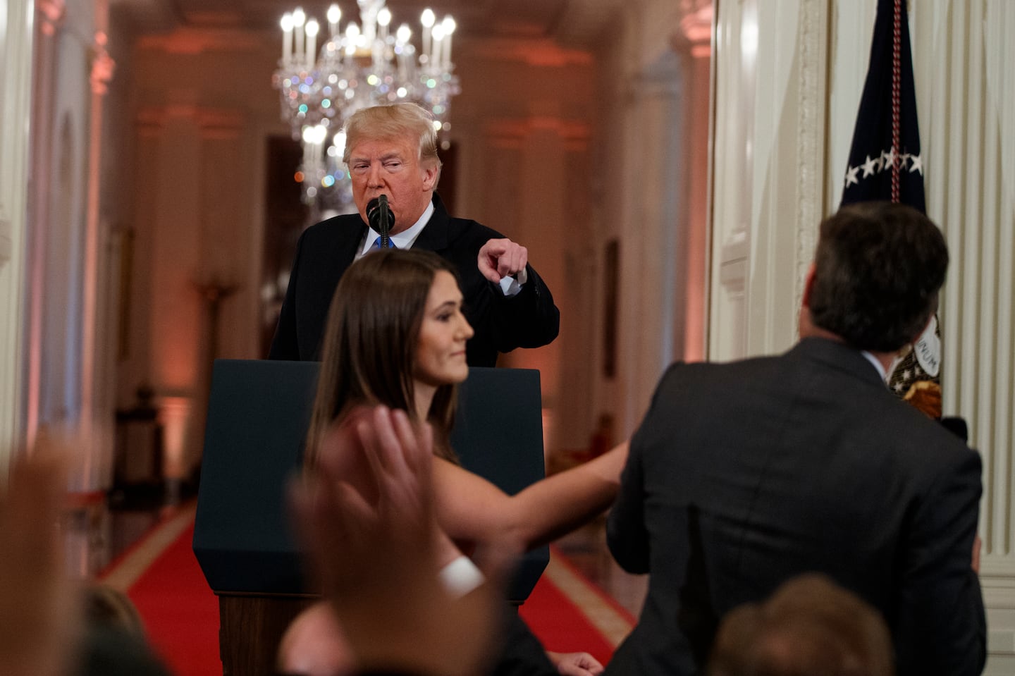 President Donald Trump looked on as a White House aide attempted to take away a microphone from CNN journalist Jim Acosta during a news conference at the White House in 2018.