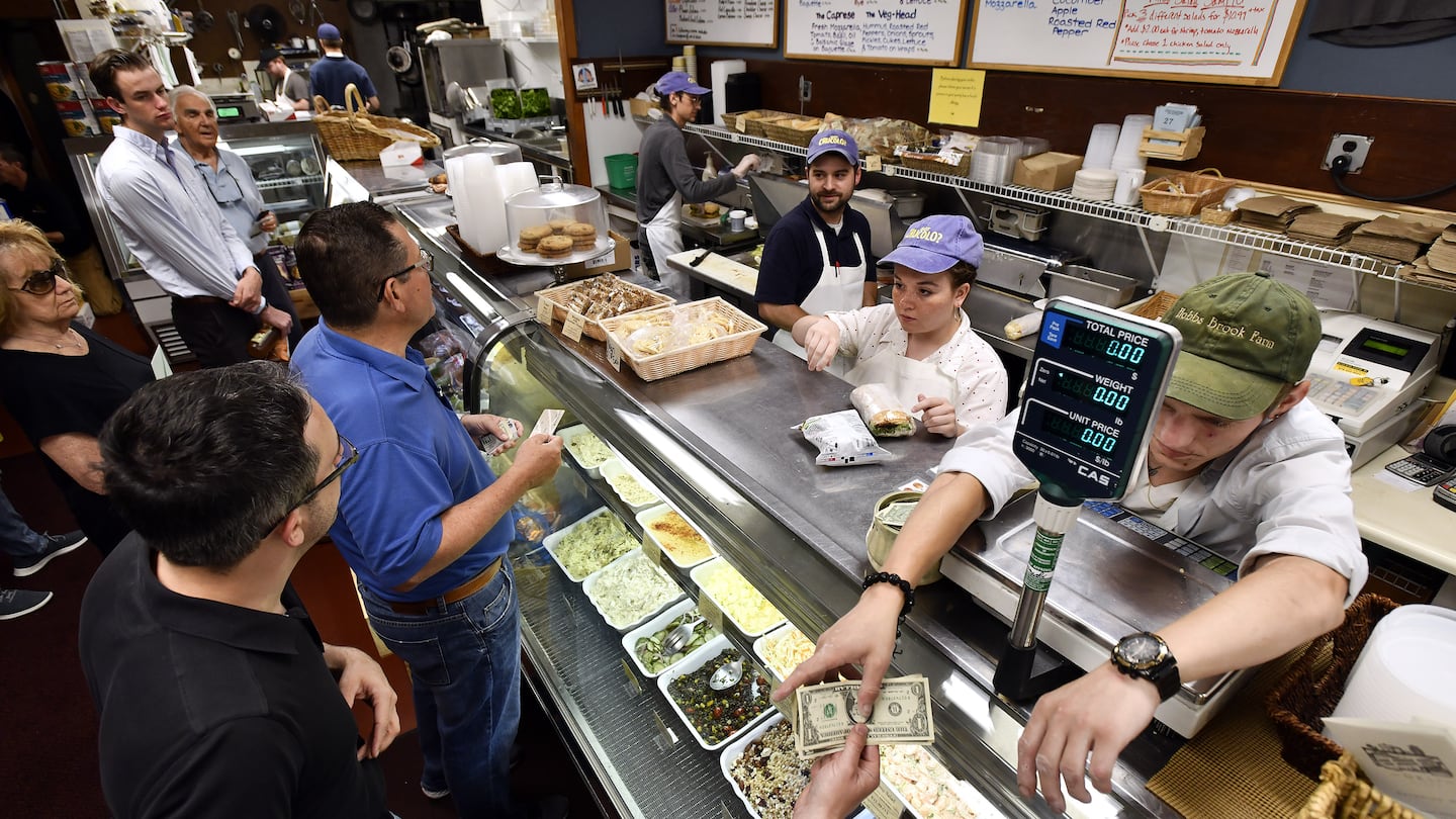 Staff assemble sandwiches during the lunch rush at the deli counter of the Concord Cheese Shop.