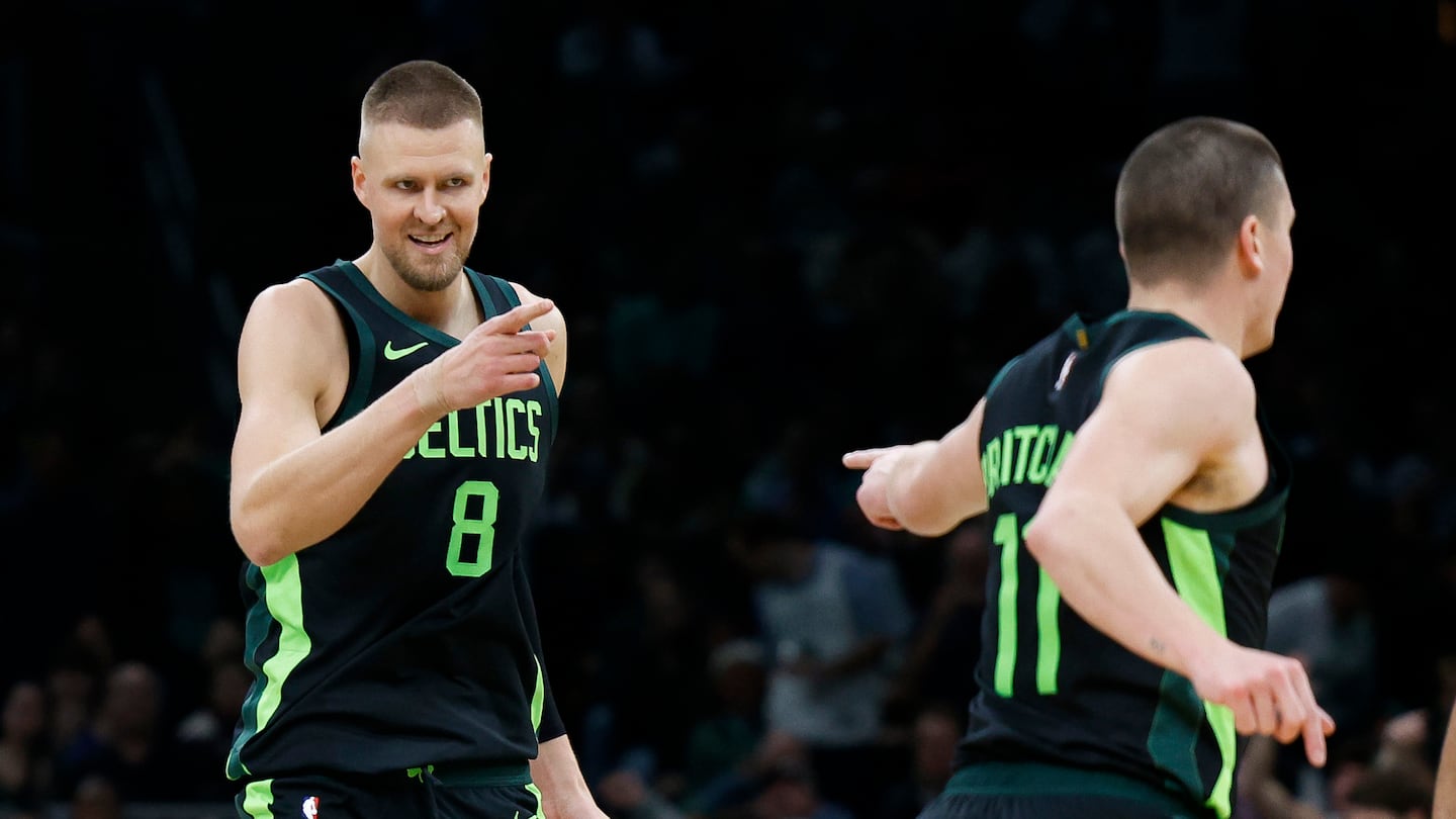 Celtics center Kristaps Porzingis (8) points to Payton Pritchard after the guard set up the big man with an alley-oop for a slam dunk in the fourth quarter of Monday's blowout win over the Clippers at TD Garden. 