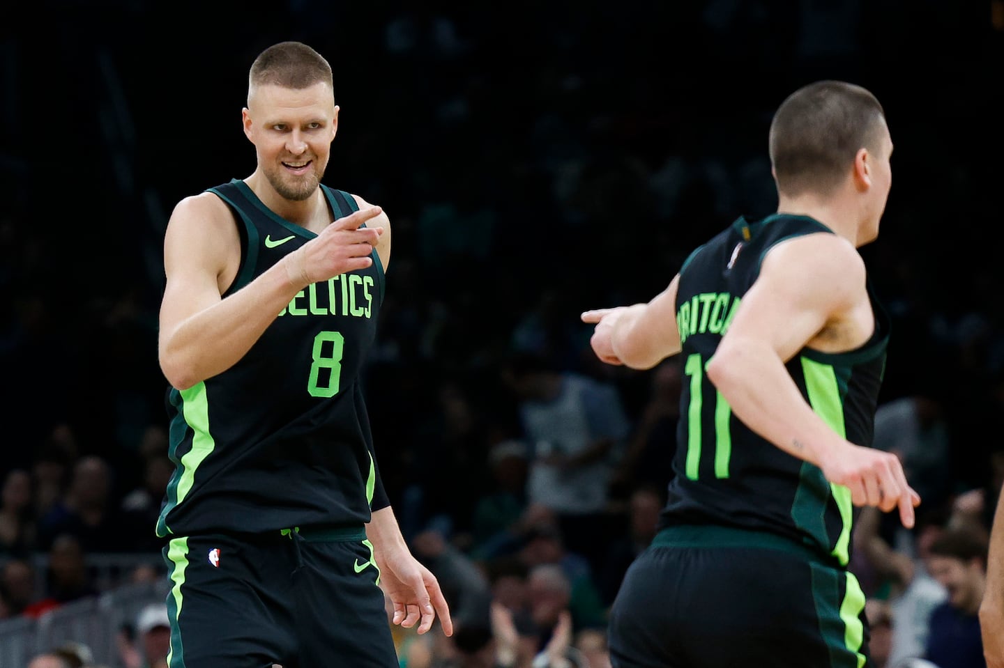 Celtics center Kristaps Porzingis (8) points to Payton Pritchard after the guard set up the big man with an alley-oop for a slam dunk in the fourth quarter of Monday's blowout win over the Clippers at TD Garden. 