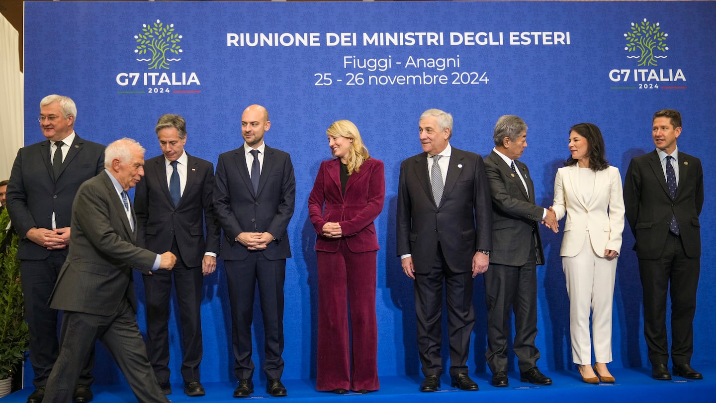 European Union foreign policy chief Josep Borrell, front, arrives to pose for a family photo with, from left, Ukrainian Foreign Minister Andrii Sybiha, U.S.