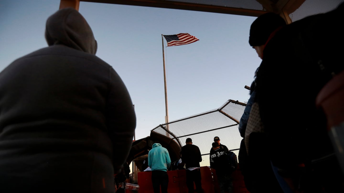 Migrants line up to present to US agents, documents requesting an appointment to apply for asylum, at the Paso del Norte international bridge, in Ciudad Juarez, Mexico, Nov. 5, 2024.