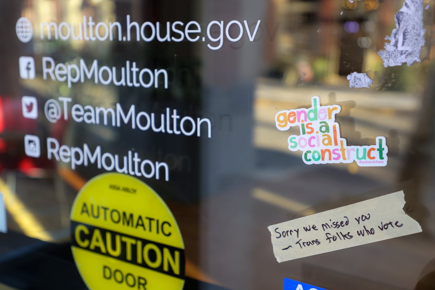 Protesters placed a sticker on the front door of congressman Seth Moulton’s office after he made comments about transgender athletes after the election.