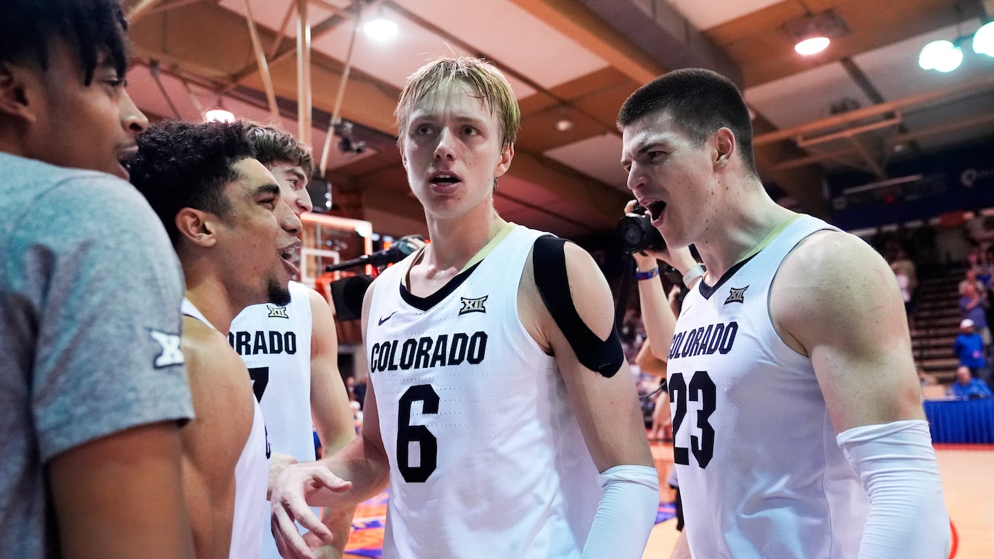 Late-game hero Andrej Jakimovski (23) celebrates with Colorado teammates (from left) RJ Smith and Sebastian Rancik after the Buffaloes handed two-time defending national champion UConn their second straight defeat at the Maui Invitational Tuesday in Lahaina, Hawaii. 