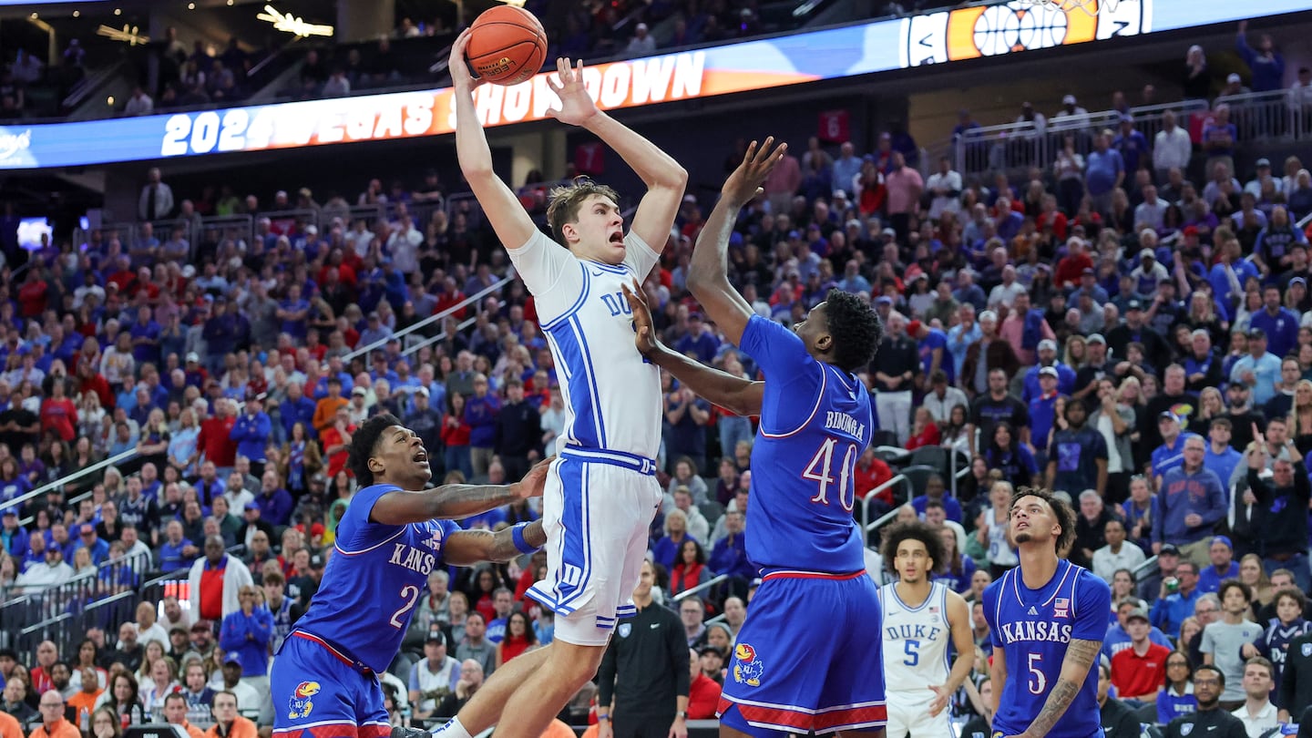 Duke freshman phenom Cooper Flagg goes to the bucket against the Kansas duo of AJ Storr (2) and Flory Bidunga (40) during the Vegas Showdown Tuesday in Las Vegas.