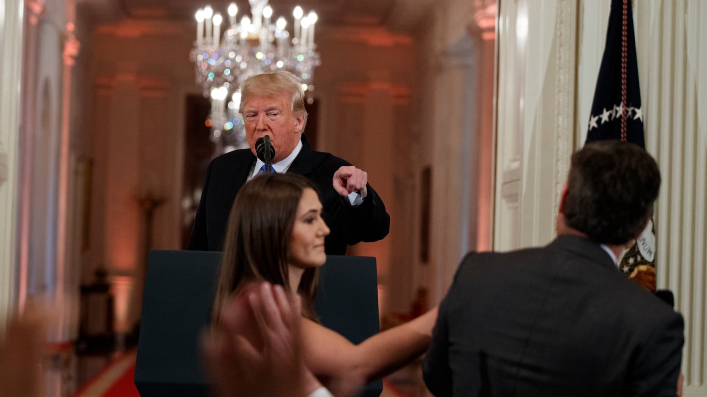 President Donald Trump looked on as a White House aide attempted to take away a microphone from CNN journalist Jim Acosta during a news conference at the White House in 2018.