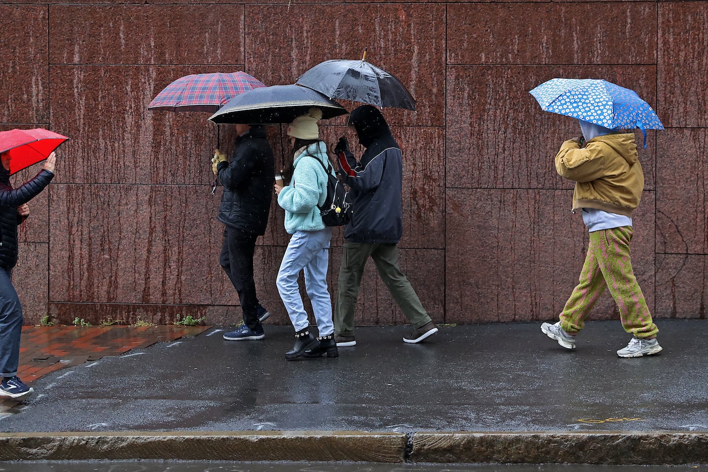 Heavy rain pours down on Congress Street in Boston on Tuesday. After a dry Wednesday, precipitation will return with the arrival of a winter storm on Thanksgiving Day.