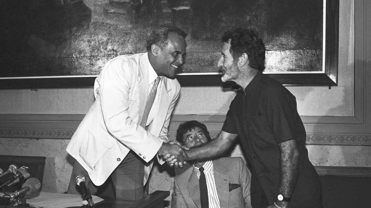 Mr. Breytenbach (right) greeted American actor and activist Harry Belafonte during a press conference in Paris in 1986.