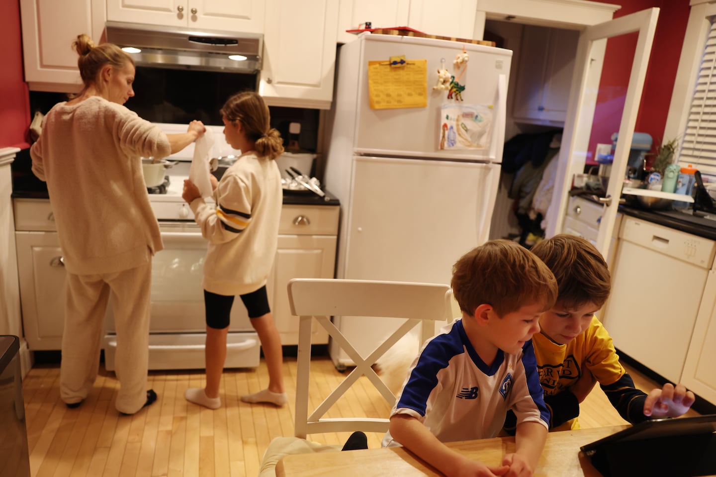 Viktoriia Susidenko and her daughter Mariia made eclairs together for Thanksgiving as Luka and Daniel played at a small table in the kitchen.