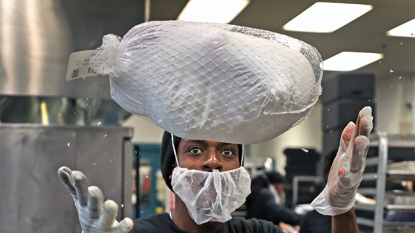 Garby, who didn't give his last name, handled a frozen turkey in the kitchen during Thanksgiving meal preparations at the Pine Street Inn.