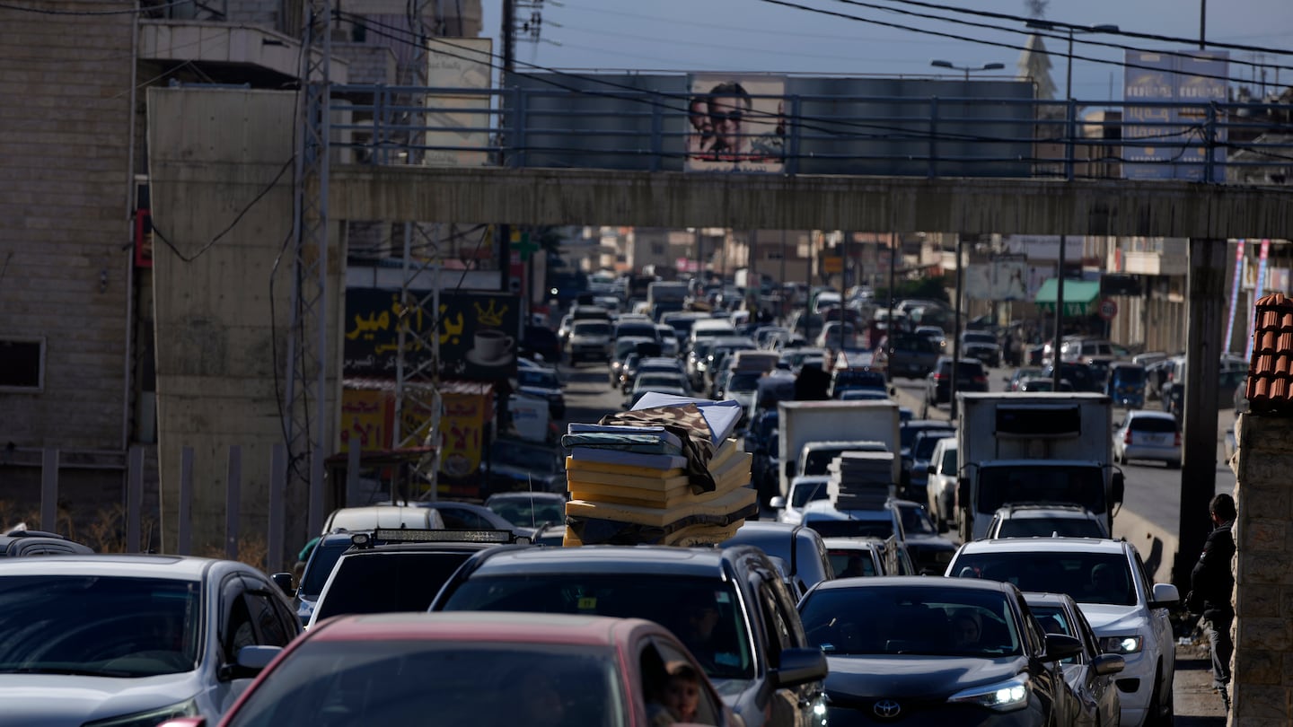 Displaced residents sit in traffic as they return to their villages following a ceasefire between Israel and Hezbollah that went into effect on Wednesday, Nov. 27, 2024, in Ablah, eastern Lebanon. (AP Photo/Hassan Ammar)