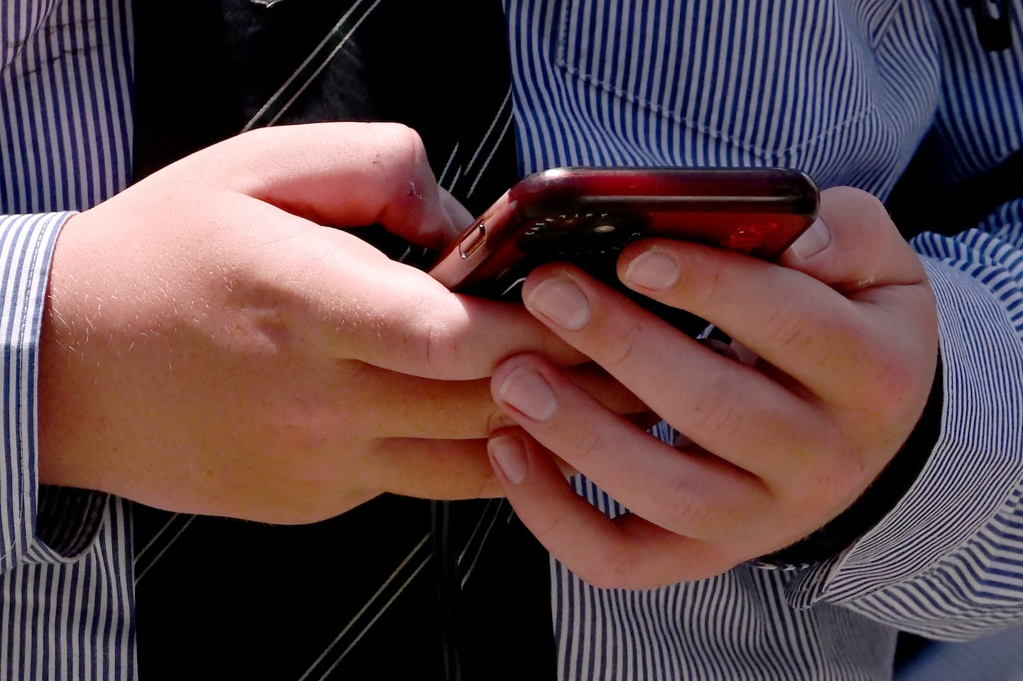 A youth looked at his phone in Melbourne on Wednesday.