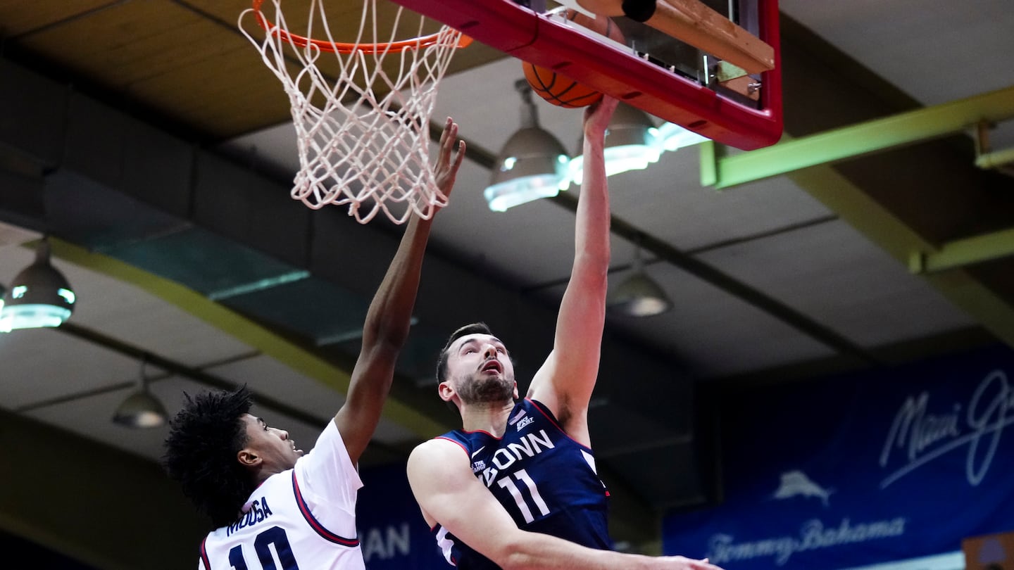 UConn forward Alex Karaban (right) was cleared to fly home with the team Thursday, according to a team spokesperson, after going to the hospital Wednesday night after heading his head on the floor in a loss to Dayton.