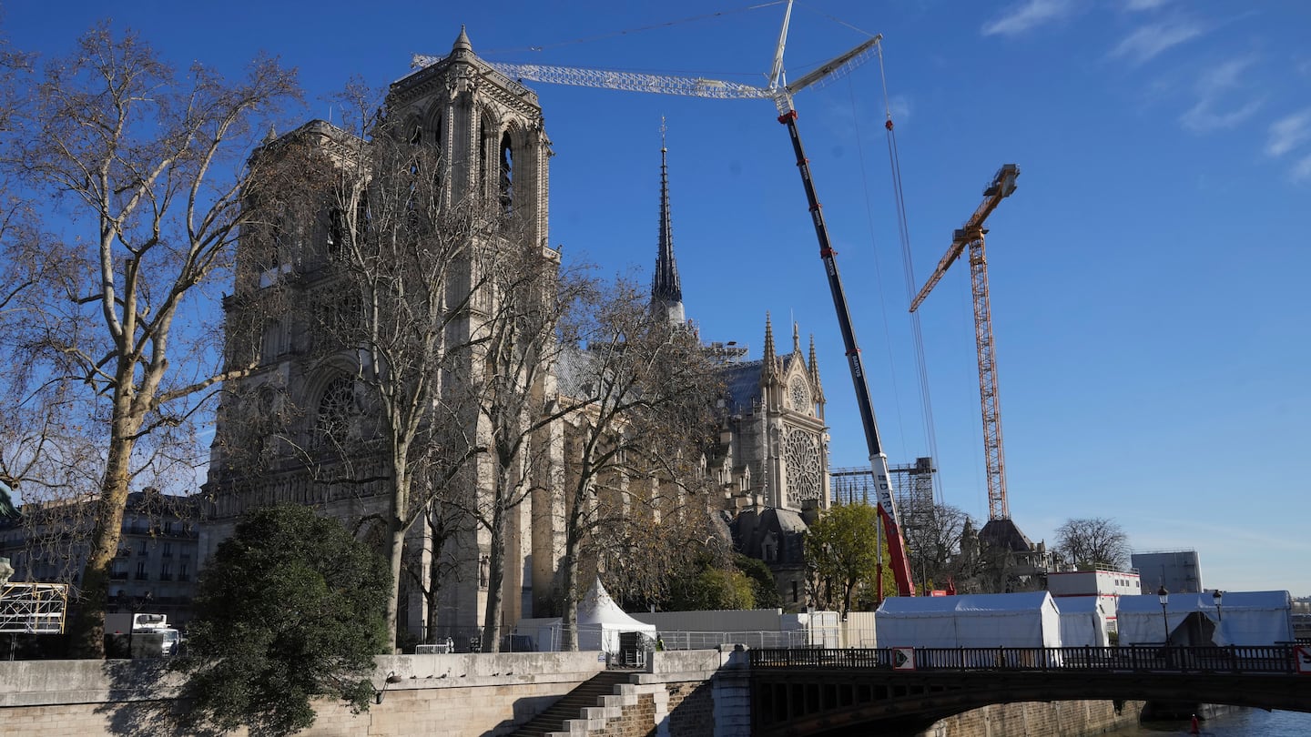 Cranes clutter the front of Notre-Dame cathedral on Thursday in Paris.