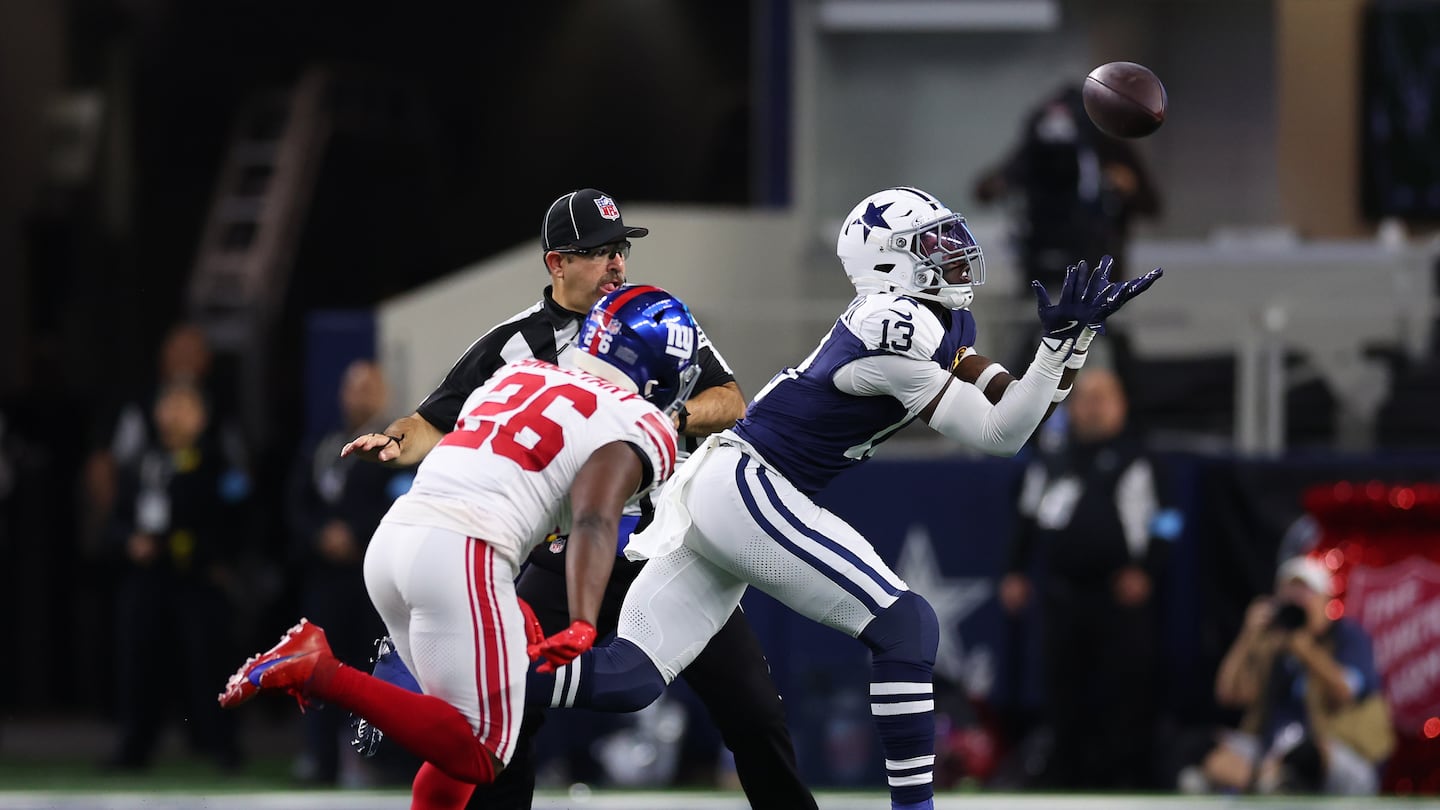 Cowboys linebacker DeMarvion Overshown (13) sees the ball into his hands and returns the interception 23 yards for a touchdown in the second quarter.