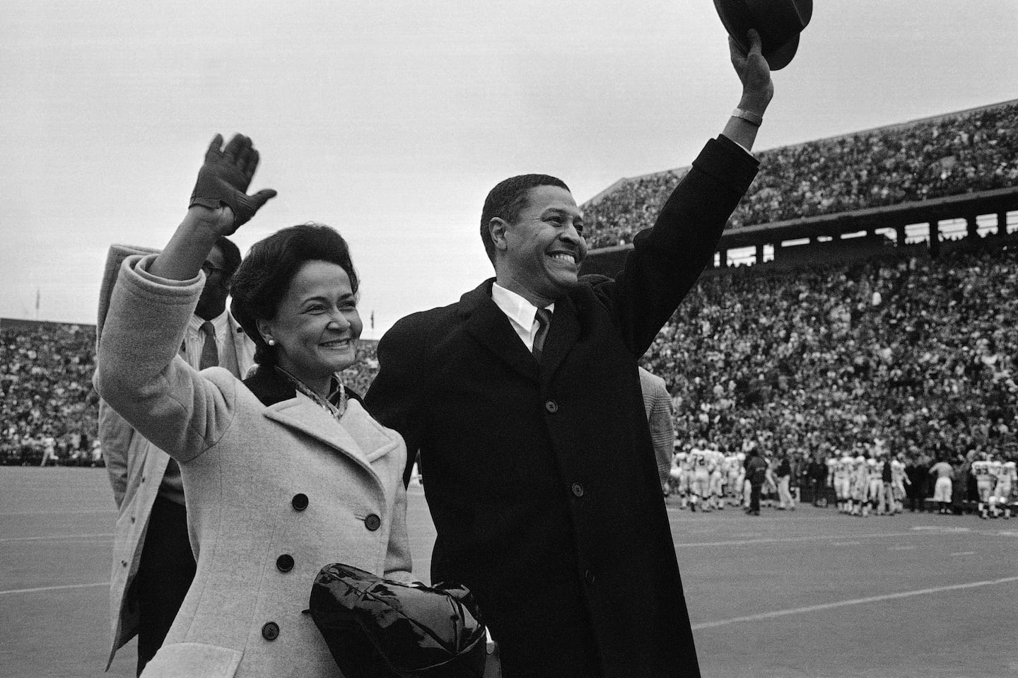 Clifton R. Wharton and wife, Dolores, acknowledge cheers from the crowd as they are introduced before start of the Indiana vs. Michigan State game in East Lansing, Mich., in 1969.