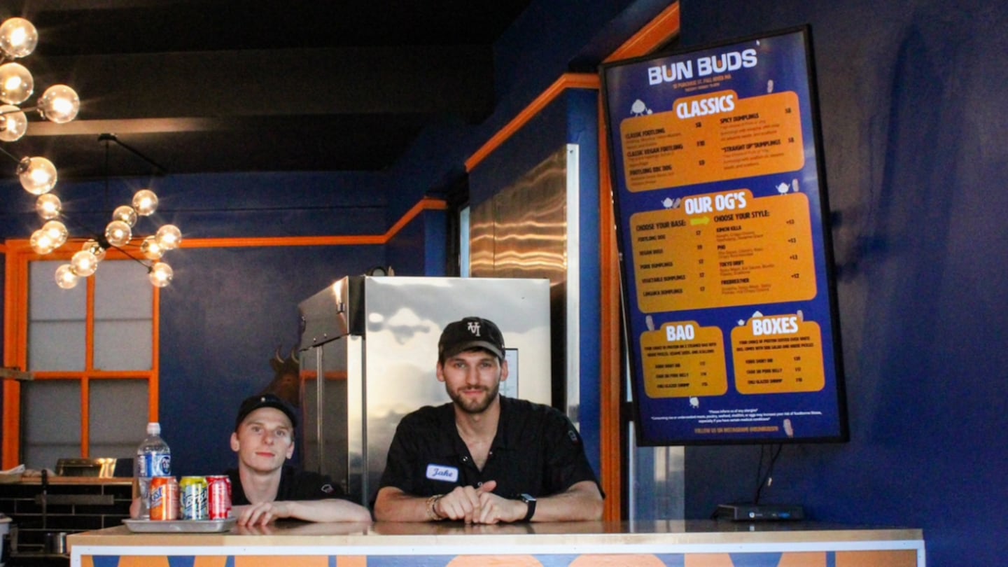 Jacob Weiss, right, got his start during his senior year at Johnson & Wales University selling hot dogs and dumplings out of a cart in Providence. In June, he opened a brick-and-mortar restaurant in Fall River, Mass.