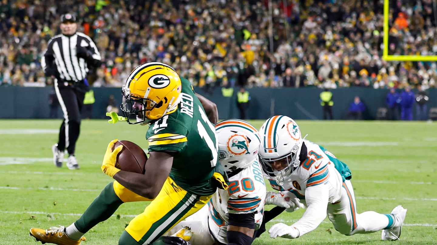 Jayden Reed catches a pass for a touchdown during the second quarter as the Packers defeated the Dolphins.