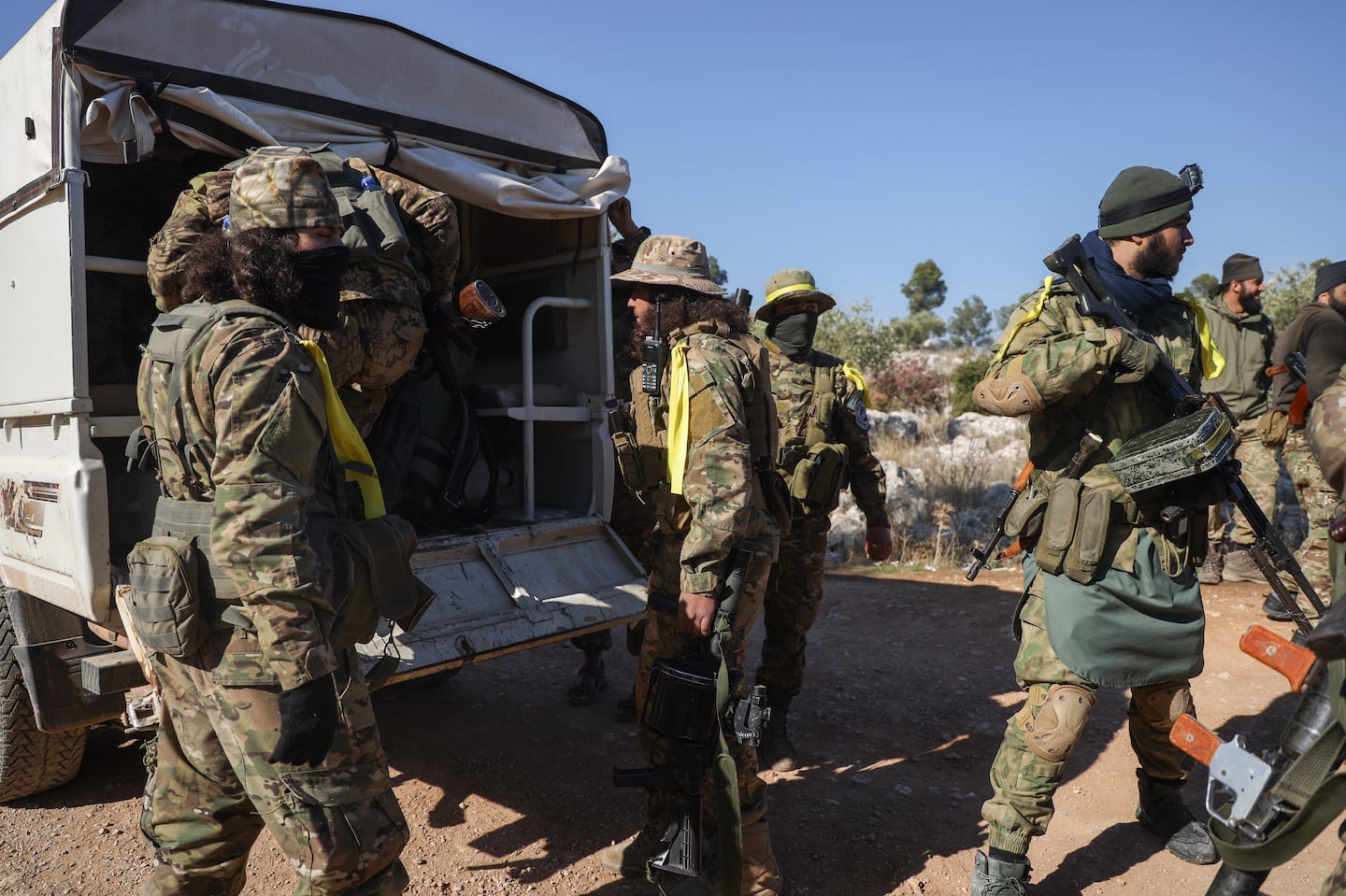 Syrian opposition fighters get off a truck as they enter the village of Anjara, western outskirts of Aleppo, Syria, Nov. 28, part of their major offensive on government-controlled areas in the country's northwestern Syria.