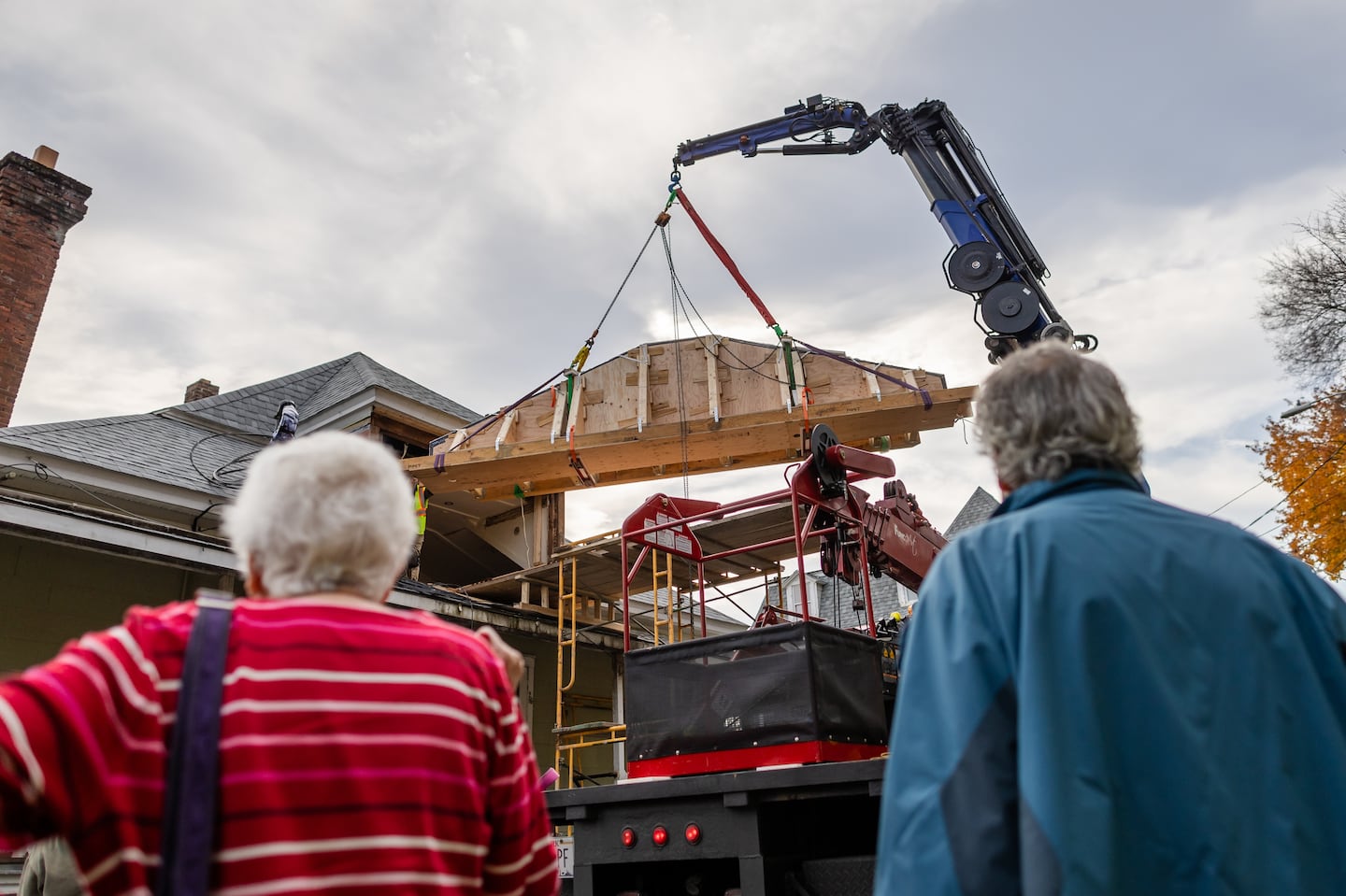 Carol Clingan and Davd Towler watched as a crew removed a 19th-century mural from the attic of an apartment building in North Adams Oct. 30. The building used to be a meeting place for a congregation of Lithuanian Jews. Clingan identified the mural and helped raise money to remove it from the property and relocate it to the Yiddish Book Center in Amherst.