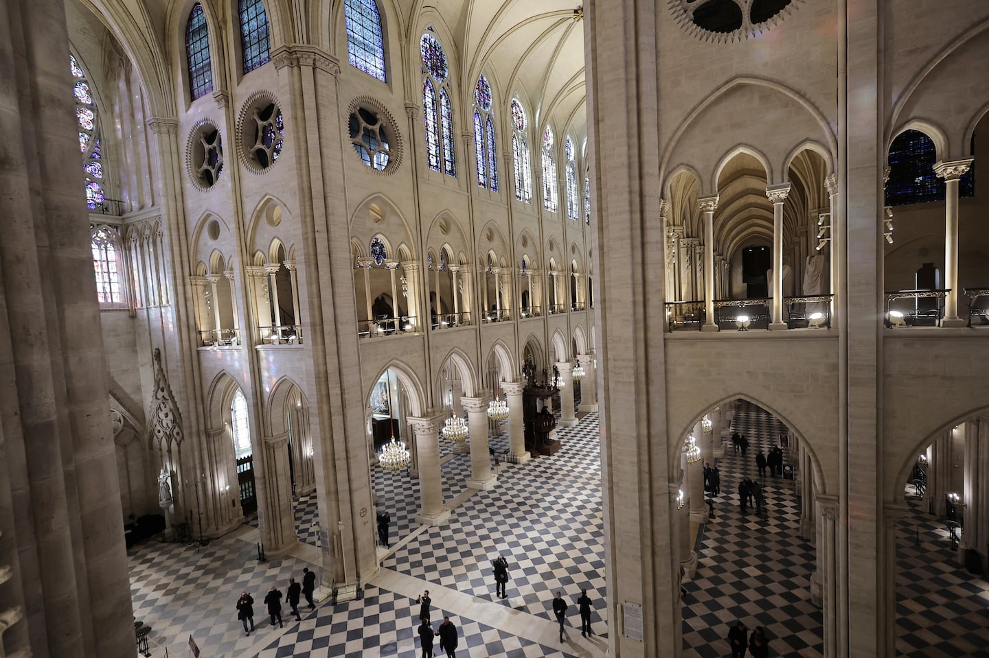 People stroll in Notre-Dame de Paris cathedral while French President Emmanuel Macron visited the restored interiors the monument, on Friday, in Paris.