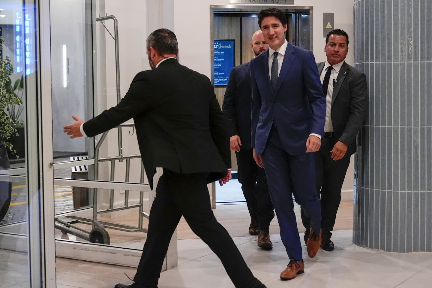 Canadian Prime Minister Justin Trudeau walks through the lobby of the Delta Hotel by Marriott, on Nov. 29, in West Palm Beach, Fla.