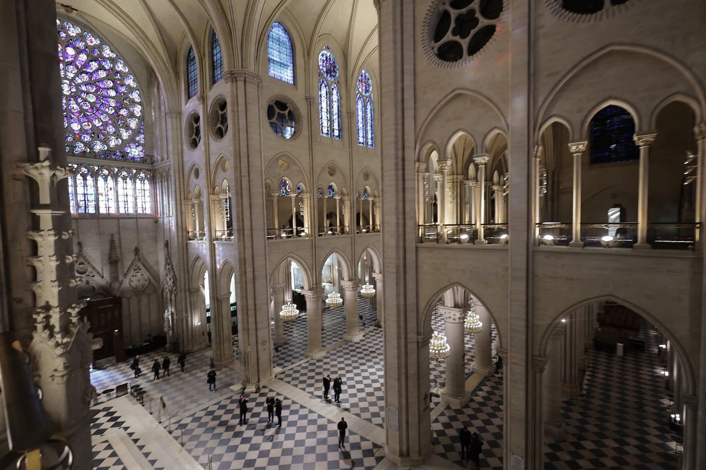 People stroll in Notre-Dame de Paris cathedral while French President Emmanuel Macron visited the restored interiors the monument, on Friday, in Paris.