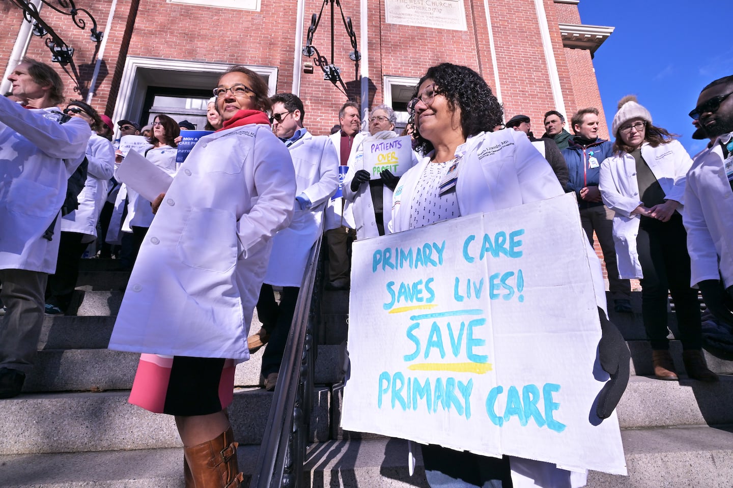 Dr. Mahmooda Quresh, center left, and Dr. Elizabeth Lincoln, center right were among the Primary Care Physicians at a news conference at Old West Church where PCPs with Massachusetts General Hospital and Brigham and Women's Hospital reacted to the Hospital network's efforts to delay a vote on the physician's petition to unionize.