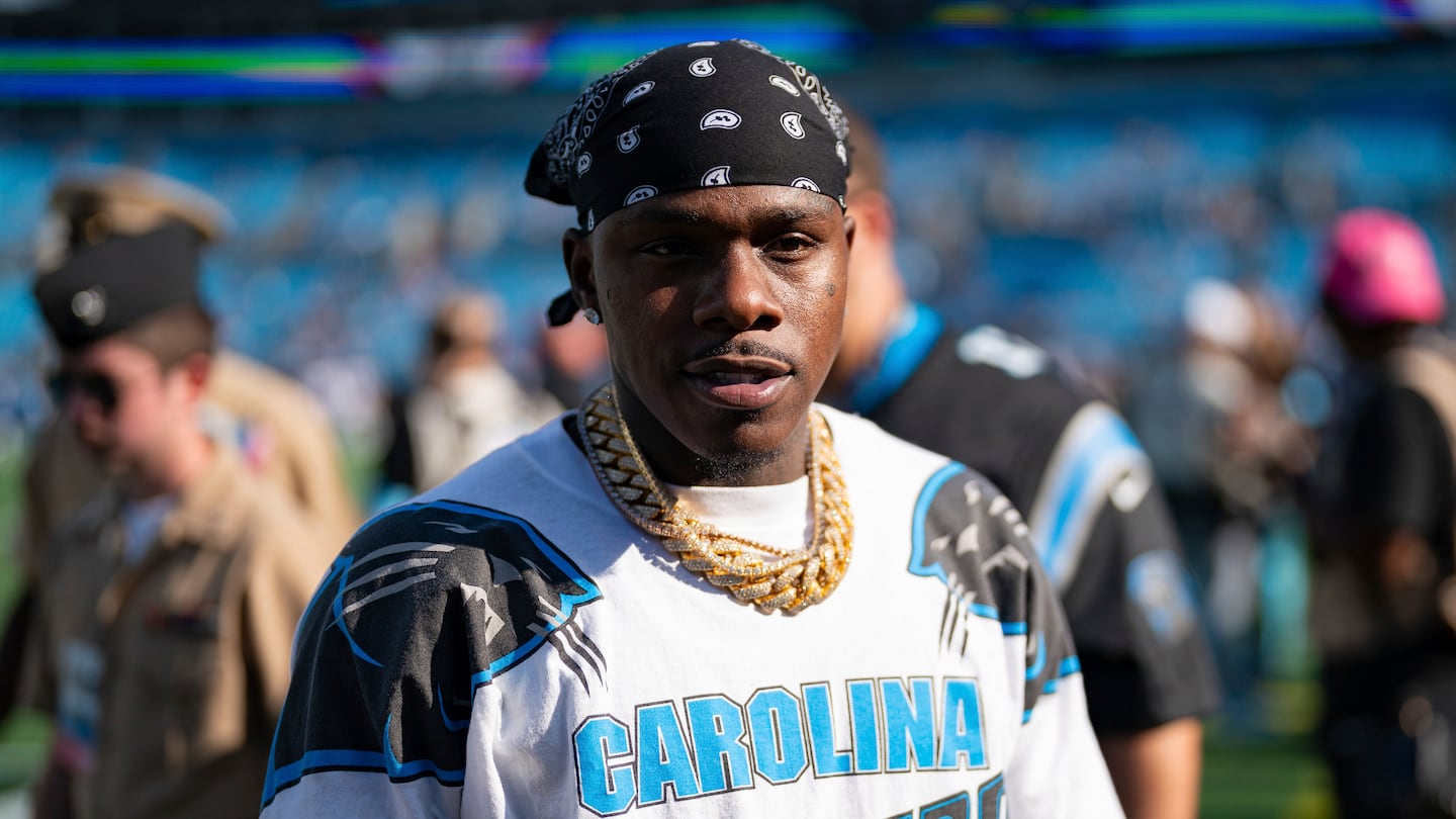 DaBaby is seen on the field before an NFL football game against the Atlanta Falcons in Charlotte, N.C.