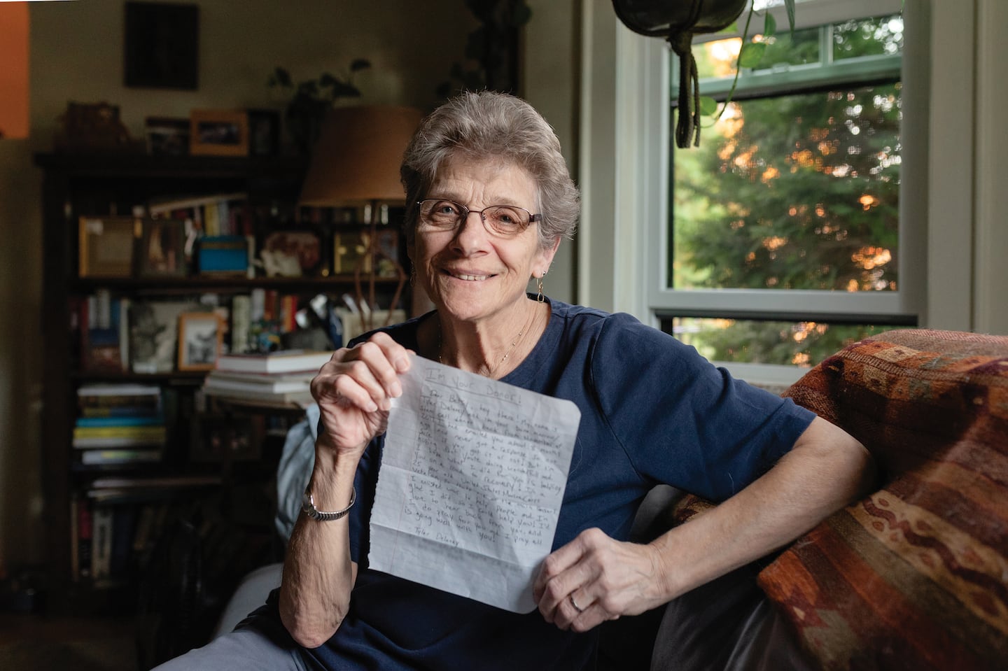 Betsy Ehrenberg holds up the letter Tyler wrote to introduce himself to her. (For privacy, the Globe obscured his contact information.)