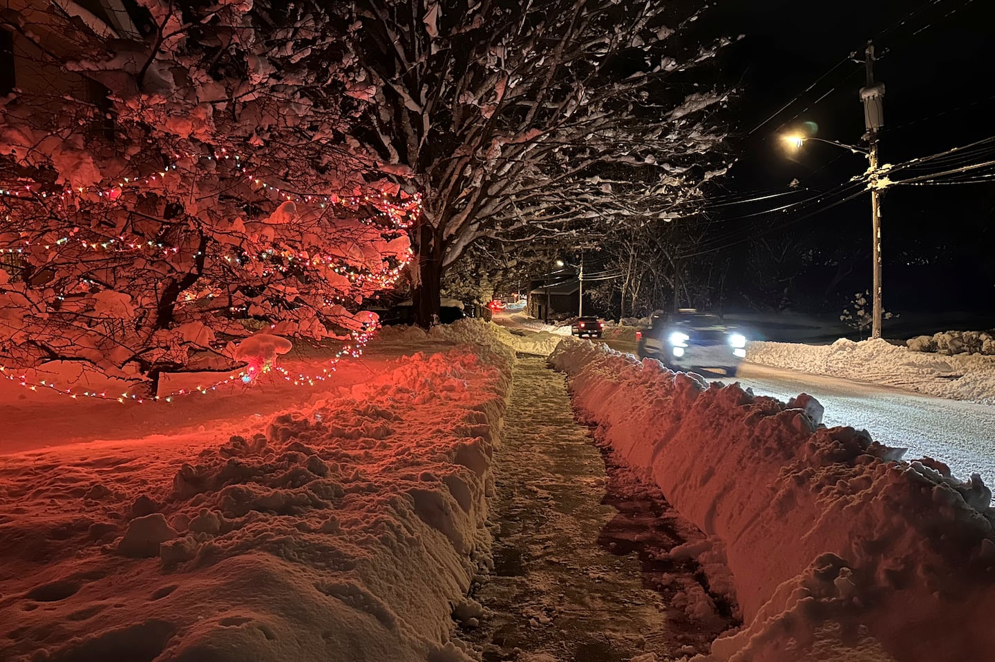 Drivers take advantage of the lull between lake-effect snowfalls in Lowville, N.Y., on Saturday, Nov. 30, 2024.