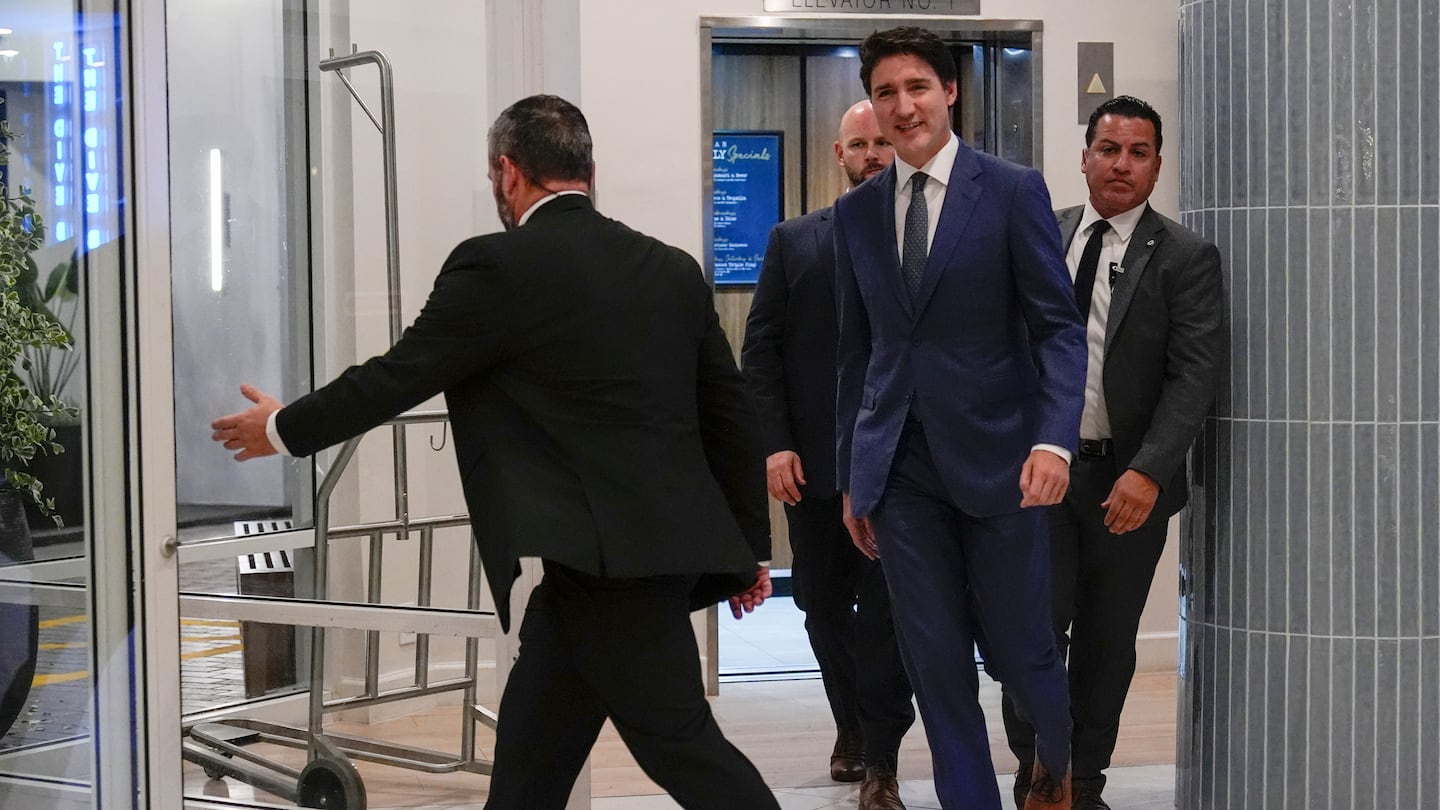 Canadian Prime Minister Justin Trudeau walks through the lobby of the Delta Hotel by Marriott, on Nov. 29, in West Palm Beach, Fla.