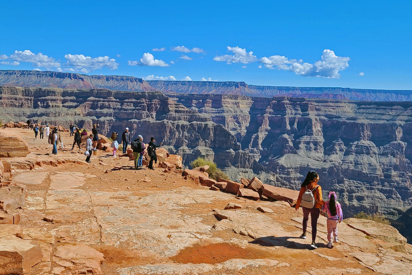 Visitors admire the striking view of the Grand Canyon and Colorado River from Guano Point at Grand Canyon West.