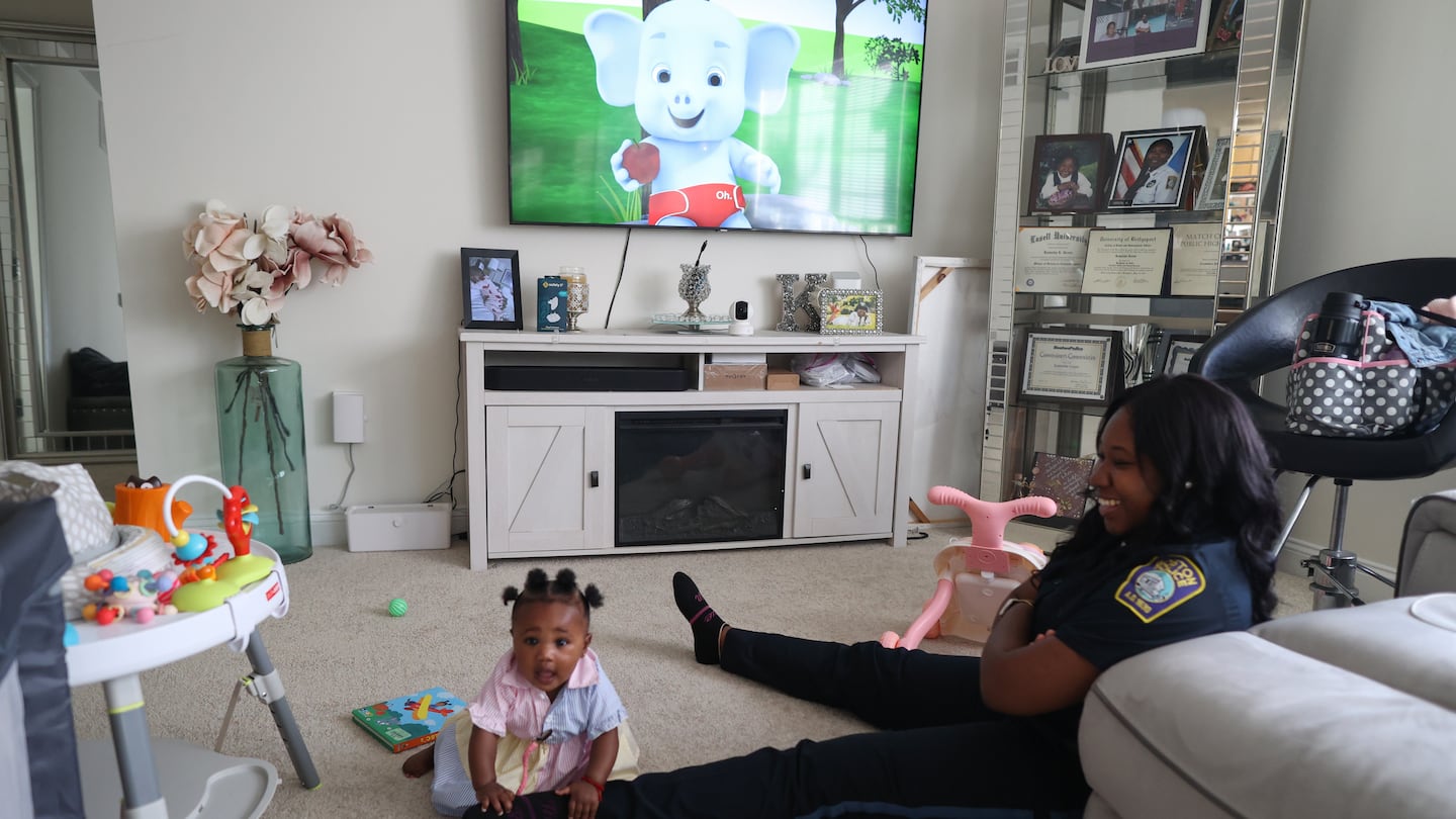 Kamisha Green, a Boston police officer, with her daughter, Zoey Grace, at their home. Green says without the city's paid family leave policy, she would've had to choose between starting a family when she wanted to, and her dream job.