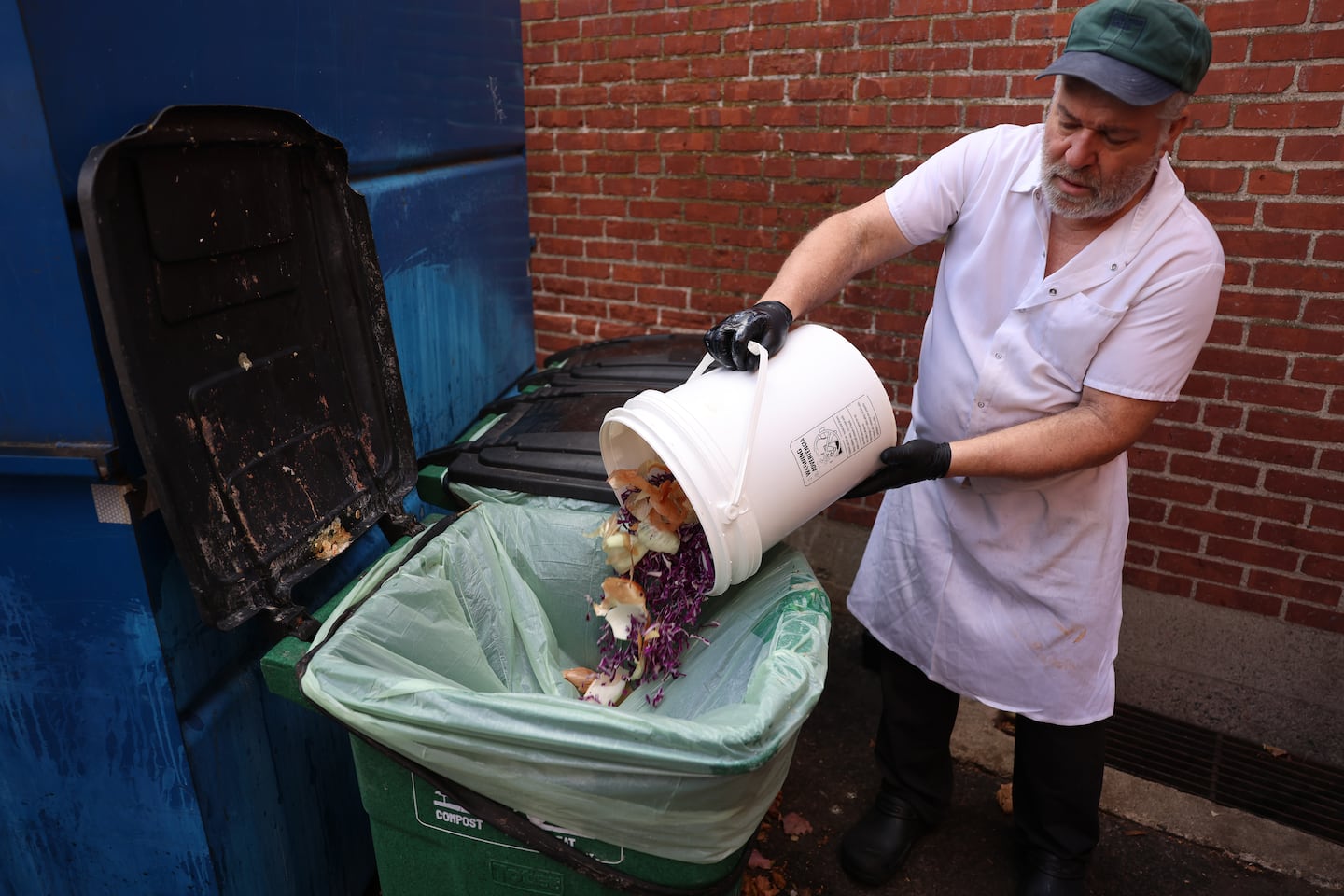 Jose Freitas took out the compost at Johnny’s Luncheonette in Newton. Massachusetts is the only state in nation to significantly reduce the amount of food waste that ends up in landfills in recent years.