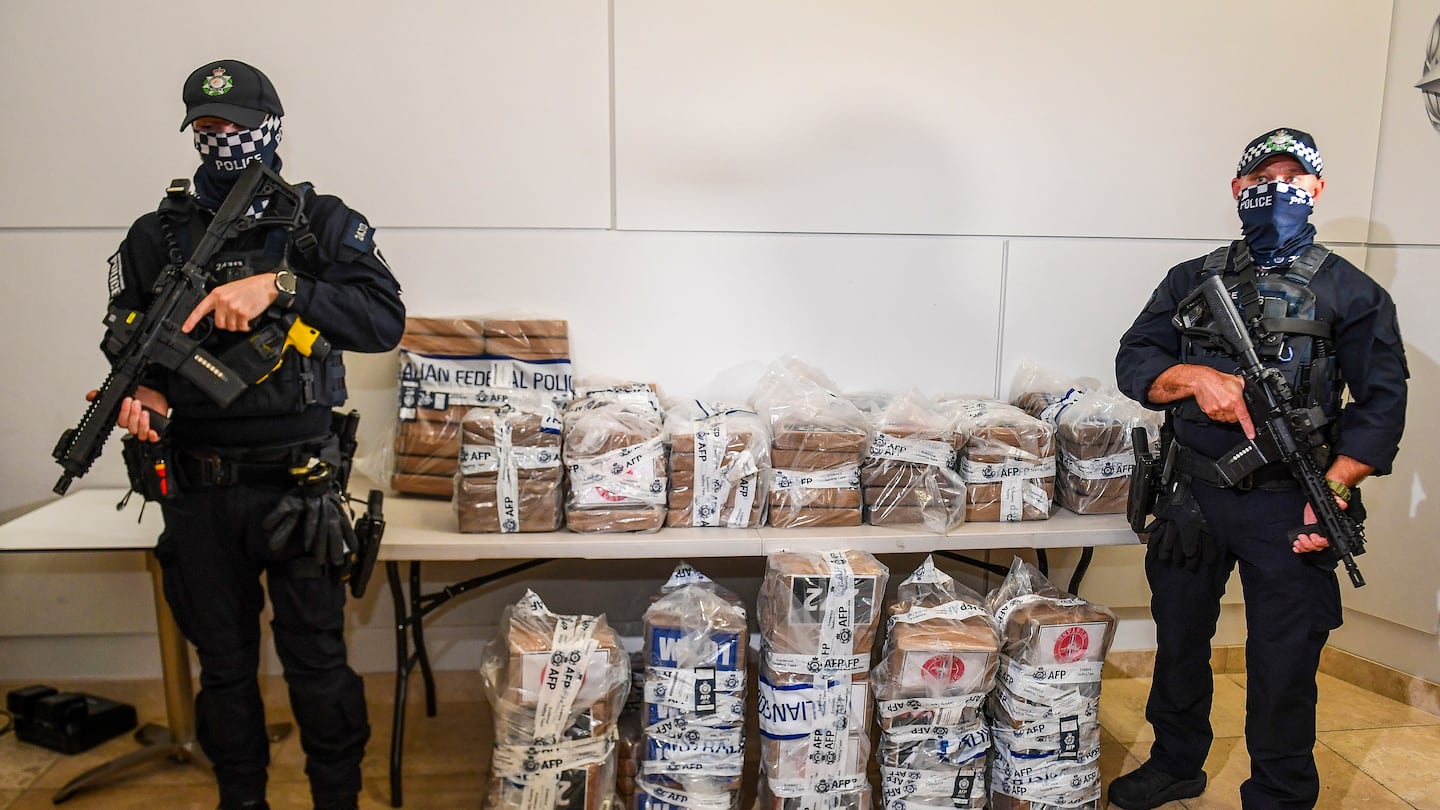 Australian Federal Police officers stand with approximately 770 pounds of seized cocaine at a press conference at the AFP headquarters in Brisbane, Australia, on Dec. 2.