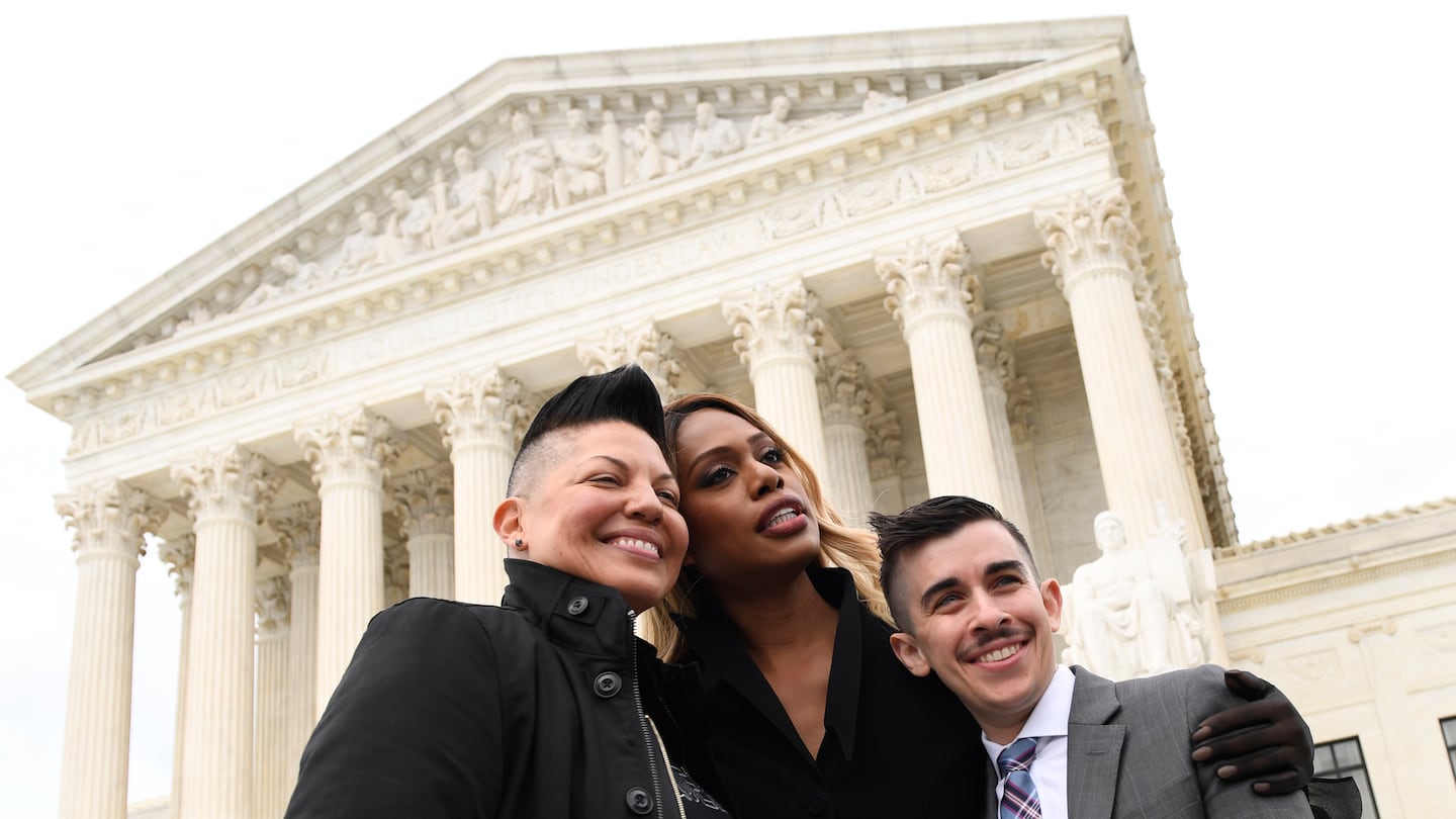 Sara Ramirez, from left, Laverne Cox, and Chase Strangio, an attorney with the American Civil Liberties Union, outside the Supreme Court in Washington, Oct. 8, 2019.