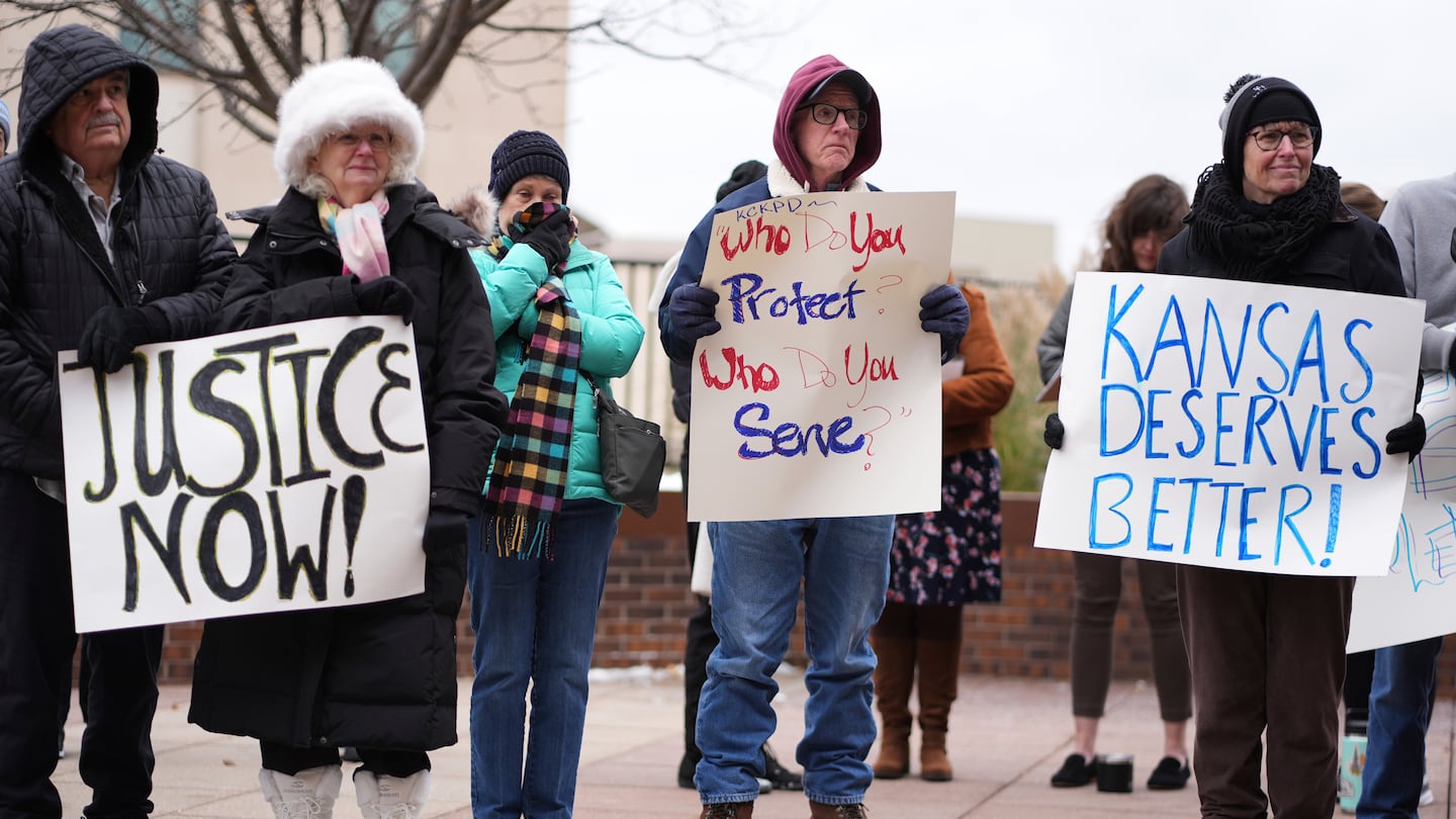 People listen to a speaker at a rally outside the federal courthouse on was was to be the opening day for a trial for former police detective Roger Golubski, Monday, Dec. 2, 2024, in Topeka, Kan. (AP Photo/Charlie Riedel)